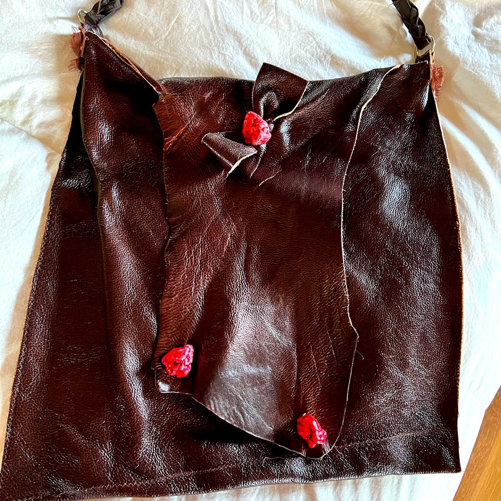 Hand crafted, cow hide/leather tote bag, adorned with large red turquoise stones